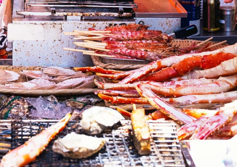 Tsukiji Fish Market: Street Food & Culture Walking Tour - Entering Tsukiji Hongwanji Temple: a quieter beginning