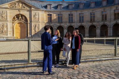 Versailles: Farmers Market & Royal Vegetable Garden Food Tour - Stop 1 on Rue de la Paroisse: le Cramique brioche and the church backdrop